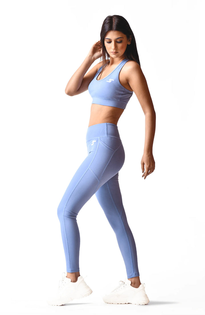 A woman wearing a blue sports bra, showcasing an active and athletic appearance.