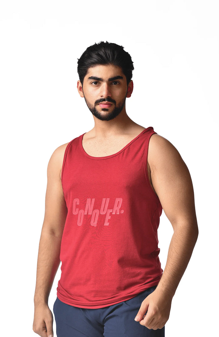 A man in a red tank top featuring the word "cnura" prominently displayed on the front.