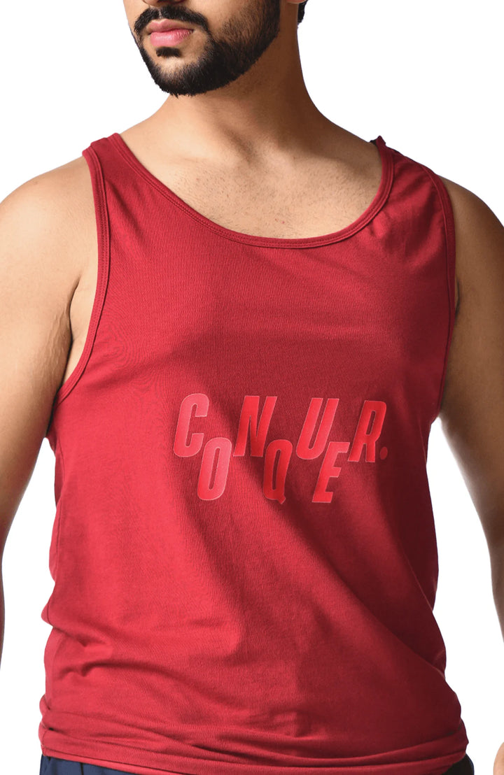 A man in a red tank top featuring the word "cnura" prominently displayed on the front.