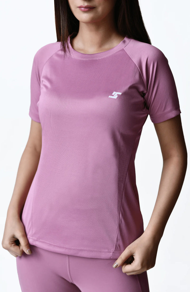 A women's pink sports outfit crafted from soft, breathable fabric, ideal for comfort during physical activities.