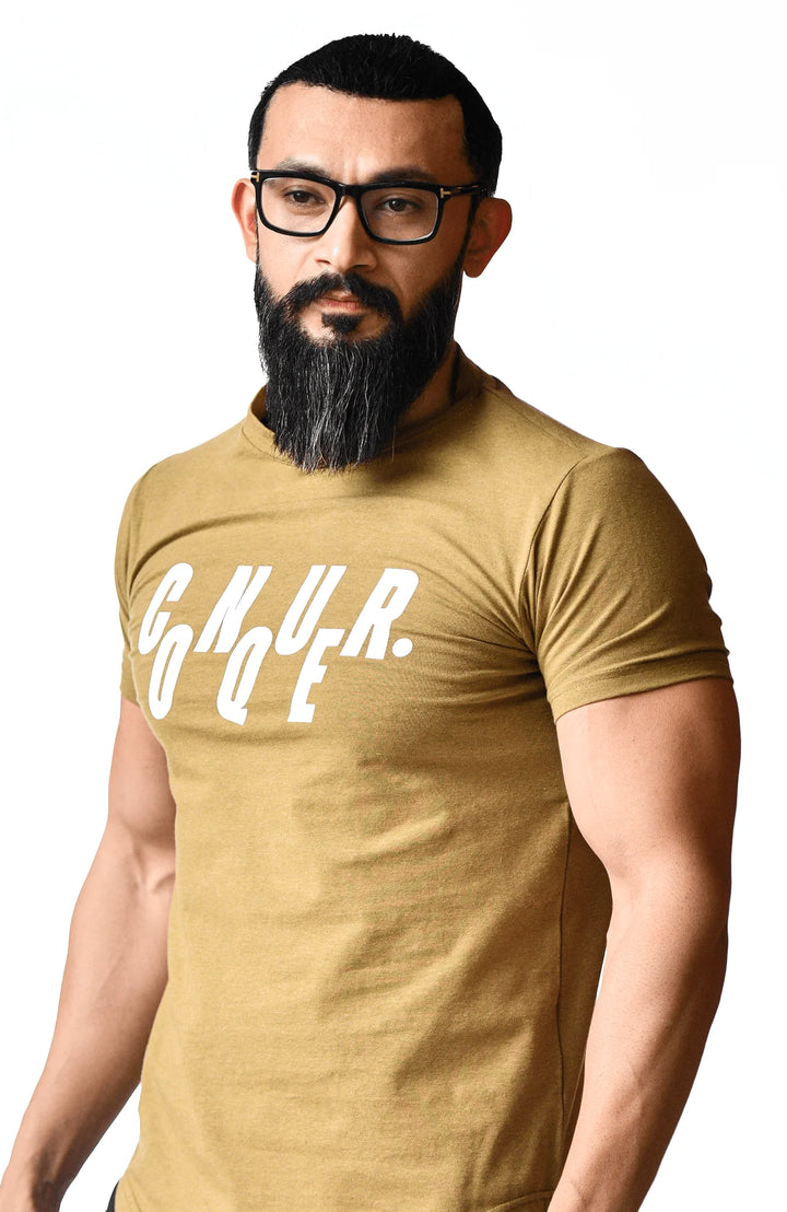 A bearded man wearing a gold t-shirt, showcasing a casual and stylish appearance.