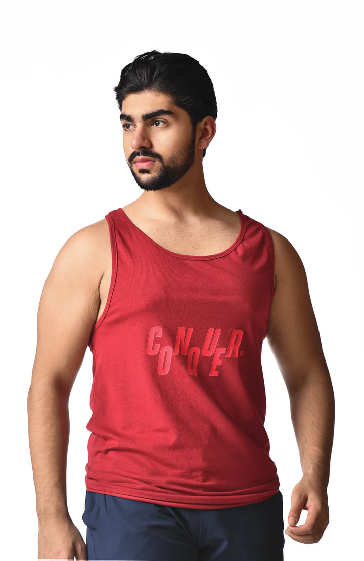 A man in a red tank top featuring the word "cnura" prominently displayed on the front.