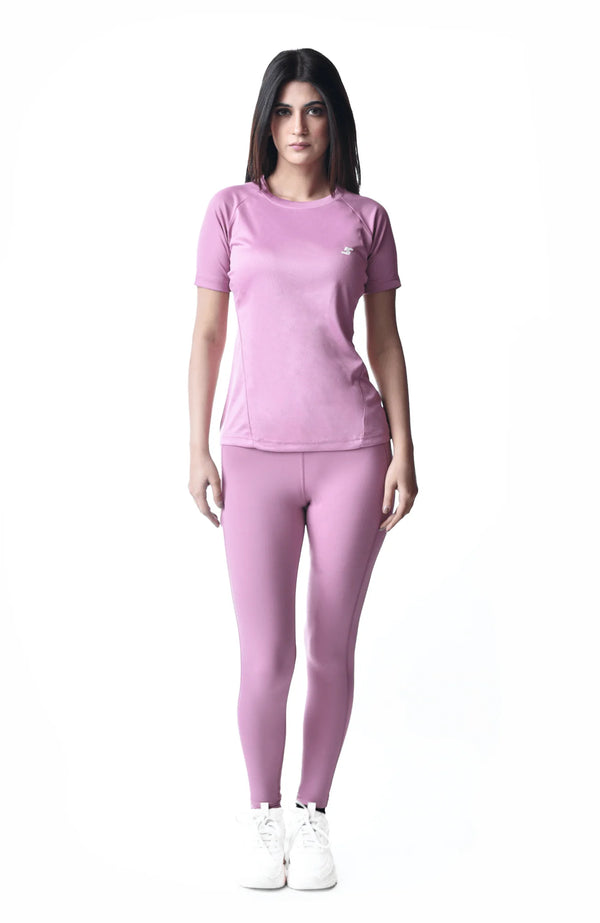 A women's pink sports outfit crafted from soft, breathable fabric, ideal for comfort during physical activities.