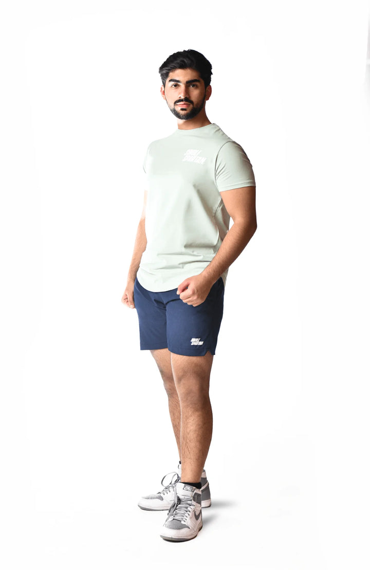 A man is dressed in a navy blue short, showcasing a casual and stylish summer outfit.
