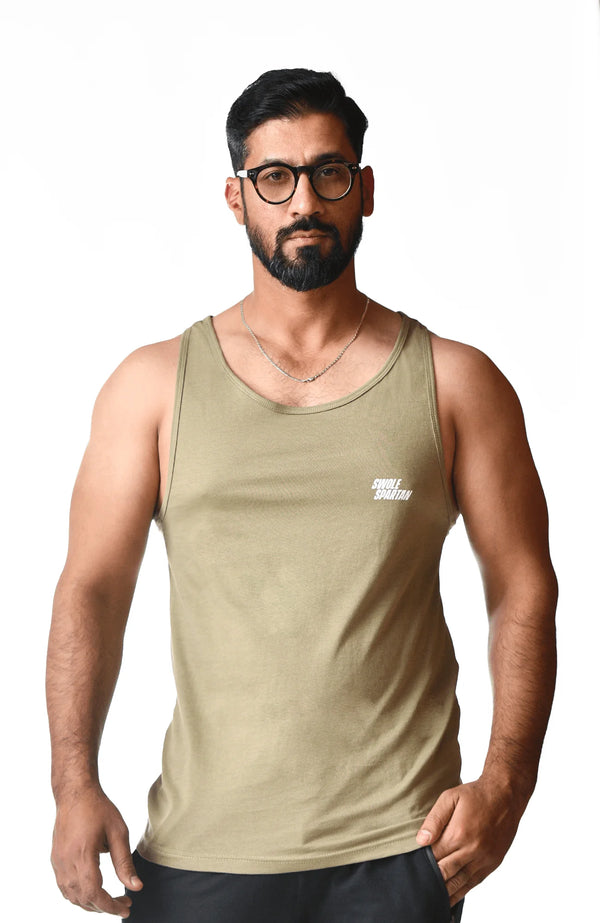  A man wearing a tank top and glasses, standing confidently with a relaxed expression.
